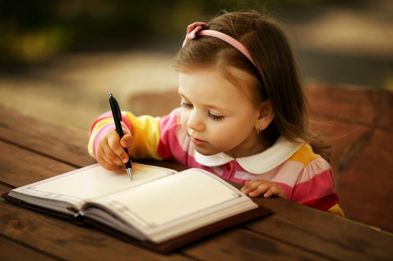 a little girl learning to write