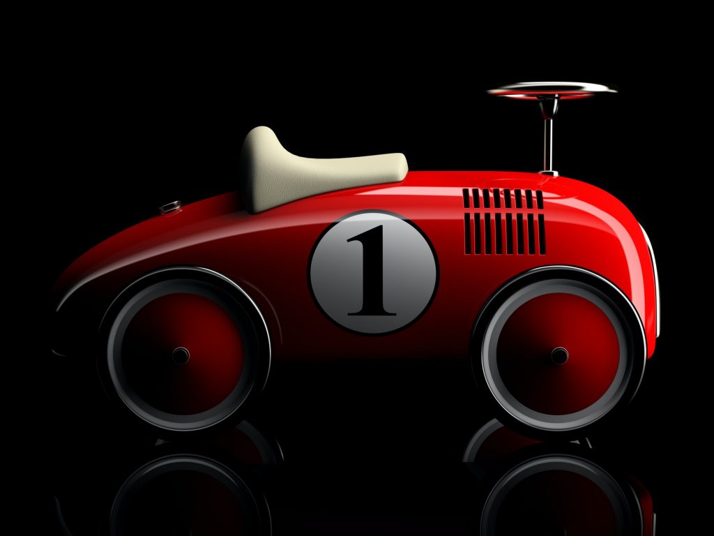 Red retro toy car number one isolated on black background