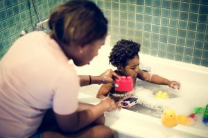 African descent kid enjoying bath tub