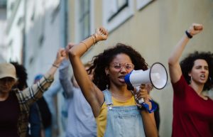 Group of people activists protesting on streets, strike and demonstration concept