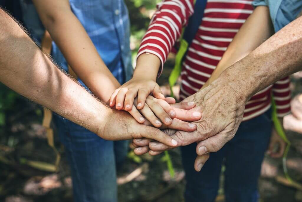 Family stacking hands as a team